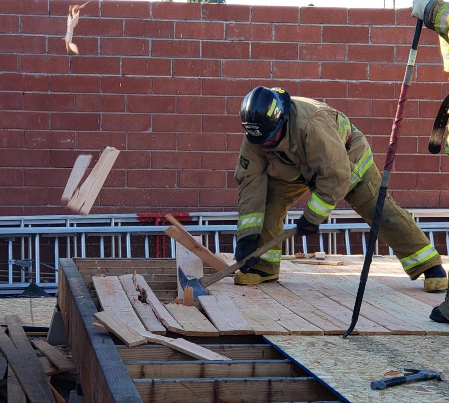 El Camino College Fire Academy student Alex Gomez practices cutting holes in wooden boards with an axe for roof operations Wednesday, Oct. 23. The academy, formerly known as the South Bay Fire Academy, has been training firefighters for 50 years. David Rondthaler/The Union