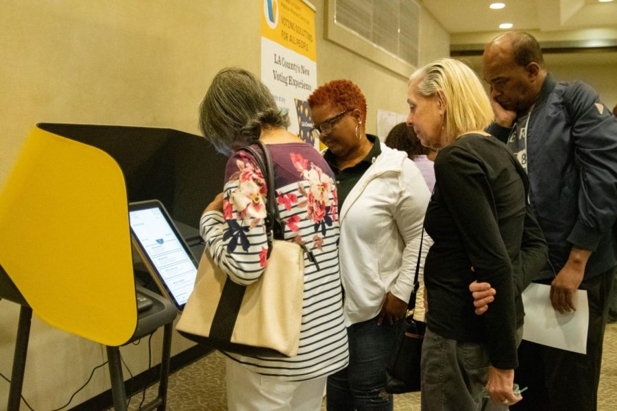 Attendees of a meeting regarding the new voting system being instated in Los Angeles County test touchscreen-operated voting machines on Saturday, Nov 2, 2019 in El Camino Colleges East Dining Room. The new program, Voting Systems for All People (VSAP) is expected to help expedite and make voting easier for those with busy schedules, disabilities and language barriers.  Rosemary Montalvo/The Union