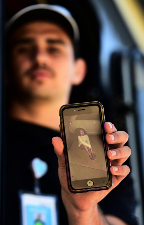 Jayden Martinez shows a photo of girlfriend Carol Higa. As an EMT worker, Jayden says he takes precautions to not expose loved ones to possible infectious diseases.
