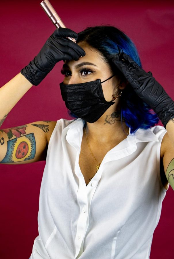 Nina Rojas poses with an instrument called the Venus, a wireless pen from Elle Marie Co. that she uses to tattoo her clients’ eyebrows–a technique known as microblading. Photo credit: Rosemary Montalvo