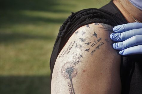 Yahaira Hernández got this tattoo shortly after her son, Juan Carlos Hernández&squot;s, disappearance late Tuesday Sept. 22. It is a dandelion being blown into the wind as a flock of birds and reads "I will carry you with me til I see you again." Image taken Wednesday, Nov. 25. (Jaime Solis/ The Union)