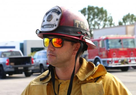 Adam Brown must wear his captain's jacket and helmet while in training. The color of a firefighter's helmet helps indicate their position. Adams' red helmet indicates to others on calls or at training that he is a fire captain. Adam also enjoys sporting a pair of sunglasses both at training and on his days off.