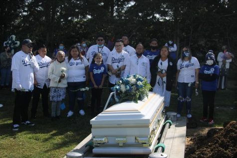 Juan Miranda's closest family gather around one last time around his body and coffin before it is lowered into its final resting place. (Jaime Solis/ Warrior Life)