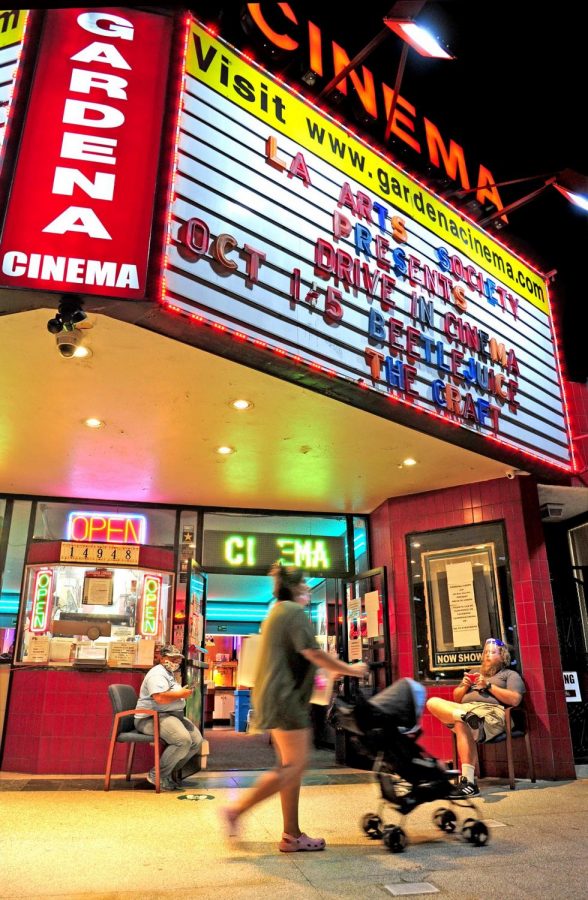 Volunteers Virginia Watson and Joseph Powers, seated left and right, watch the theater entrance during open hours. The Gardena Cinema is showing drive-in movie during the pandemic shutdown, while the snack bar and restrooms are open to patrons.

Photo by Gary Kohatsu/Warrior Life Magazine