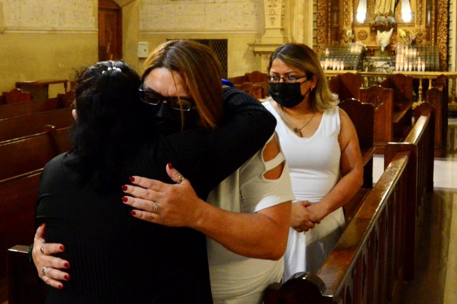 Juan Carlos Hernandezs mother, Yajaira Hernandez, receives a hug from a woman at the conclusion of the mass memorial at the Saint Paul de Vincent Parish in Los Angeles. Her sister Stephanie Pineda, far right, stands back with hands clasped. Losing my nephew has been difficult because it has changed everything, Pineda said. I lost someone close to me. We had a very close relationship as aunt and nephew. Theres not a day that goes by that I dont think of him. It feels like yesterday. It doesnt even feel [like] a year. Its difficult to talk about him or think of a memory without having a tear drop go down buy face or having a knot in my throat. His loss is something that I will never get over...Theres always that what if question.  Photo by Jose Tobar/The Union Photo credit: Jose Tobar