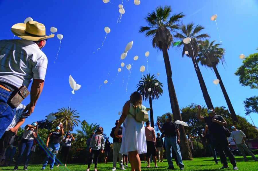 Family members and friends release balloons into the sky in a symbolic gesture honoring the memory of murdered El Camino College student, Juan Carlos Hernandez outside the church grounds at the Saint Vincent de Paul Parish on Wednesday, Sept. 22, 2021. We released the balloons as a symbol of our love for Juan. Sending our love, our prayers and thoughts, Hernandezs mother Yajaira Hernandez said. It represents family, unity and love. Every balloon that was released had a little bit of our pain in it. The loss of an amazing son, brother, cousin and friend. Photo by Jose Tobar/The Union Photo credit: Jose Tobar