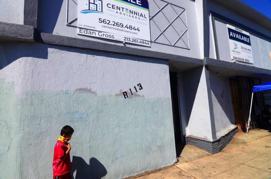 Six-year-old Erick Melendez, wanders outside the dispensary's storefront where his cousin, Juan Carlos Hernandez was murdered on Sept. 22, 2020. Melendez was very close to Juan and two would spend time together almost everyday, Yajaira Hernandez said. Hernandez's family friends will place a sidewalk memorial outside its wall. Photo by Jose Tobar/The Union