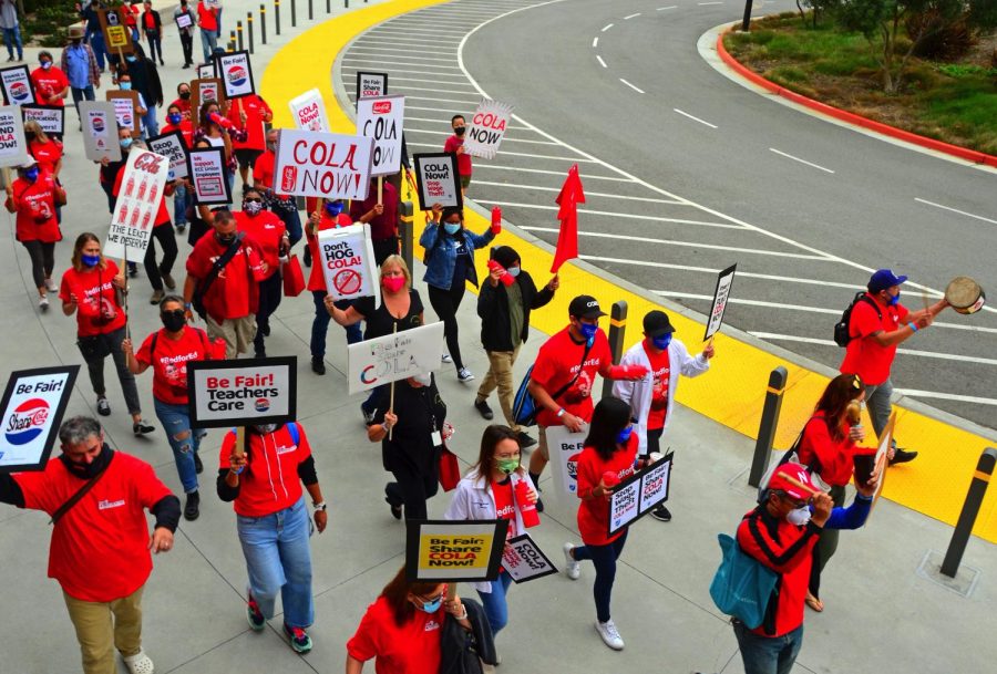 A large crowd of El Camino College Federation of Teachers members and their supporters march past the Student Services building during their educational campaign on Thursday, Oct. 7, 2021, chanting, “What do we want? COLA. When do we want it? Now.” After months of negotiations the union and the district have yet to reach an agreement over the Cost of Living Adjustment the union proposed as a retroactive 3.26% COLA increase to their salaries, according to a union press release. Photo by Jose Tobar/The Union