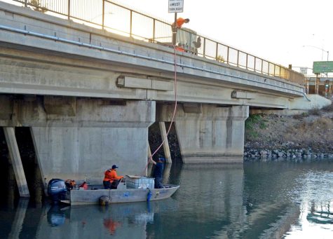 Ocean Blue Environmental Services, Inc., workers refill their boat with Epoleon, an odor neutralizer that converts hydrogen sulfide into salt, just off Chico and 213th street in Carson on Saturday, Nov. 13. Photo by Jose Tobar/The Union