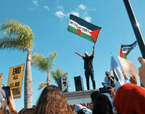 As speeches are given during protests in Anaheim in collaboration with CSULB and the Palestinian Youth Movement (PYM), protestors wave Palestinian flags on Friday, May 21. Safia Ahmed/The Union