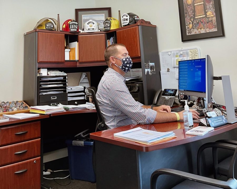 Chief Jeffrey Baumunk, El Camino College director of public safety, working in his campus office on Nov. 1. Baumunk leads a department that includes ECC's fire academy, as well as certification and degree programs in fire science, policing and emergency medical services.