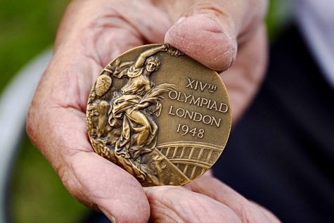 George Stanich, 93, holds the bronze medal he won in the high jump at the London Olympics in 1948, at his Gardena residence on Monday, Nov. 1. Photo by Greg Fontanilla/The Union