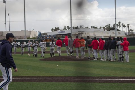 Coach Nate Fernley leaving the field while Long Beach Vikings players celebrate their victory against ECC Warriors. El Camino was defeated by LBCC 5-2 on Feb 22, 2022. ELCO will play against LBCC again on Feb 24, 2022 this time in Long Beach. Photo by Vitor Fernandez/The Union at El Camino College, Torrance, CA.