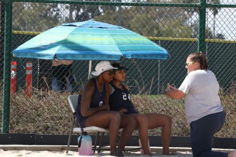 Enriquez and Goods receive instruction from Coach Liz Hazell after winning the first set against Santa Ana College's Kassandra Zavala and Angela Hill at home on Thursday, March 3. The Warriors defeated the Dons 5-0. Photo by Greg Fontanilla/The Union