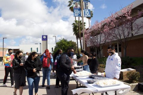 Student members of the the BSU and SEAC hand out Black and African inspired meals to hungry and curious students at the BSU's eat-and-greet event in front of the Student Center Plaza on Feb.22, 2022.