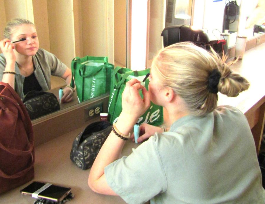 In the womens dressing room at Campus Theatre on Sunday, March 20, Olivia Currys preparation started off with her hair wrapped in a bun. Olivia then grabbed the CoverGirl mascara from her black and white makeup kit in the center, then started applying it to her left eye. (Sharlisa Shabazz | The Union)