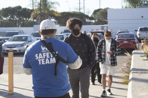 A line of students formed to get autorization clearance for wristbands at the south east entrance of the El Camino College campus. Students have to get the wristbands in order to prove that they have no symptoms or contact with COVID-19. March 1, 2022. Vitor Fernandez/The Union.