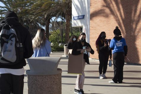 Students pass by Marsee Auditorium at El Camino College in order to meet with World Back to Work employees for access to campus on Tuesday, March 1. Students must retrieve colored wristbands from World Back to Work Check-in Kiosks in order to have access to campus. (Vitor Fernandez | The Union)