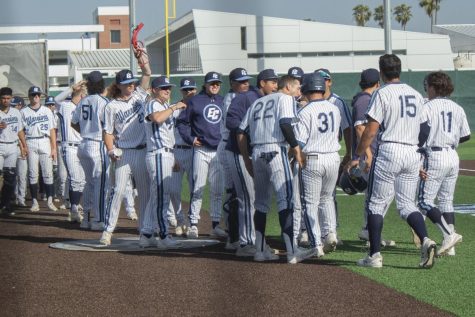 The Warriors bench celebrates Jorge Alonso Renteria's (#31) two-run blast to left field. The game took place on March 10, 2022, at Warrior Field in Torrance, CA. Photo by Vitor Fernandez.