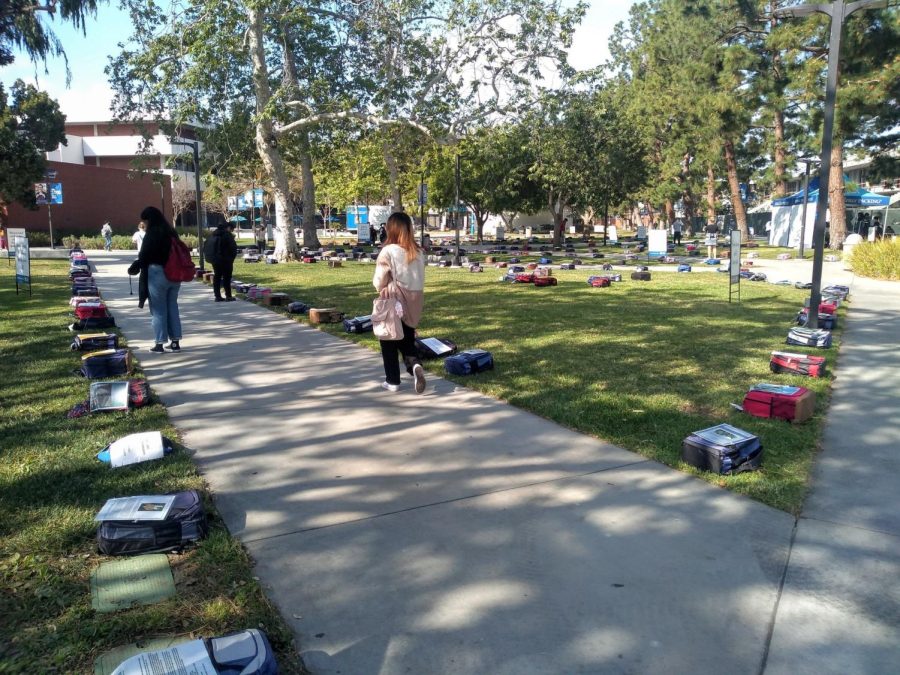 Backpacks spread out on the library lawn at the Send Silence Packing event at El Camino College Monday, April 4. The backpacks have a picture and a brief story about an individuals story with suicide and how it impacted those closest around them. (Charlie Chen | The Union)