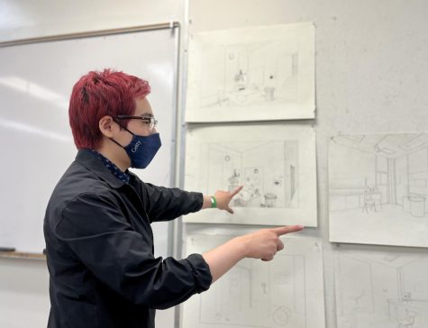 Marcus looks through the work of students in the drawing Drawing Fundamentals I at Room 207 in the Arts and Behavioral Science Building. Marcus is a teaching assistant for Joseph Hardesty's drawing classes.