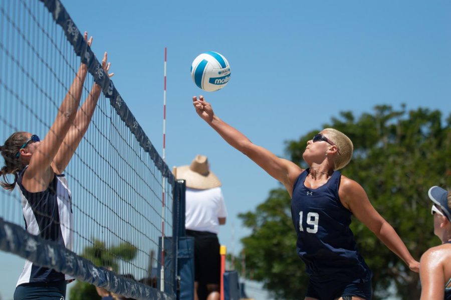 El Camino Beach Volleyball player Fayth Rascon (right) motions to avoid a block from opponent Jaclyn Sanchez (left) during a game against Irvine Valley College College at Irvine Valley College   Sand Courts on Thursday, May 12, 2022. Rascon and partner Lauren McCarthy lost sets in the overall match loss against the Lasers . (Naoki Gima | Union Photo)