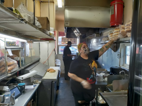 Angelina Rodriguez and Omar “Alexander” Flores Co-owners of Alexander's World Famous Torta restaurant wear face masks while filling out orders in their kitchen on a Friday November 2, 2021 The co-owners are also a married couple. Delfino Camacho | The Union.