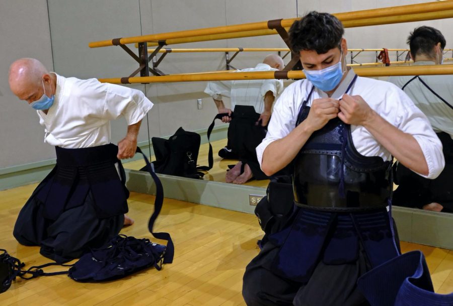 After warm ups and the katas practice ends, Tony Smith (L) and Ruben Ramirez, 30, methodically put on their “Bogu”, a protective armor worn by naginataka for sparring. It consists of the sune-ate (shin protectors), men (head gear), kote (fencing gloves), do (chest protector), and tare (waist protector and a tenugui, a headband). (Jose Tobar | Warrior Life)