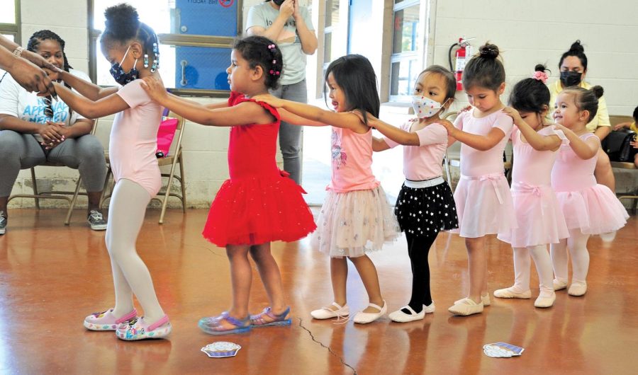 Dance students connect via the choo-choo train line parade around the dance room. Children as young as 2 take part in Tamara Kemp’s Dance One class, which consists of tap and ballet. Tamara has more than 10 dance classes and each class will eventually perform at various Gardena community events, Tamara says. (Gary Kohatsu | Warrior Life)