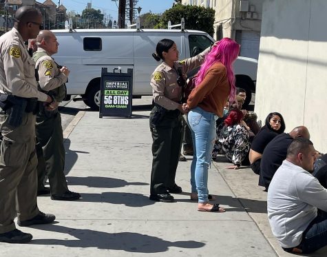 A Los Angeles County Sheriff's Department deputy conducts a pat-down during a raid on the Imperial Green House marijuana dispensary on Imperial Highway between New Hampshire and Berendo in South Central Los Angeles on Wednesday, March 9. (Kim McGill | The Union)