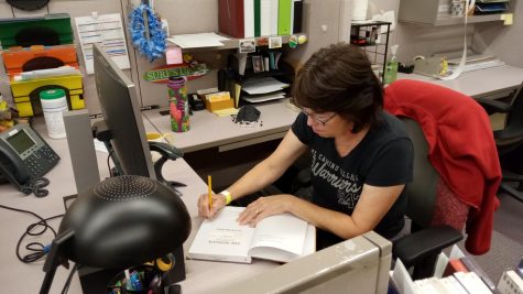 El Camino College Library and Learning Resources Specialist Laurie Pelayo catalogs a book at her desk on Wednesday, Oct. 20, 2021, in El Camino College Schauerman Library. Laurie has been with ECC for 40 years.