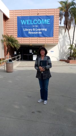 El Camino College Library and Learning Resources Specialist Laurie Pelayo shows her father's yearbook on Thursday, Nov. 18, 2021, in front of ECC Shauerman Library. Laurie, her father, mother, brother and all three children are ECC alumni.