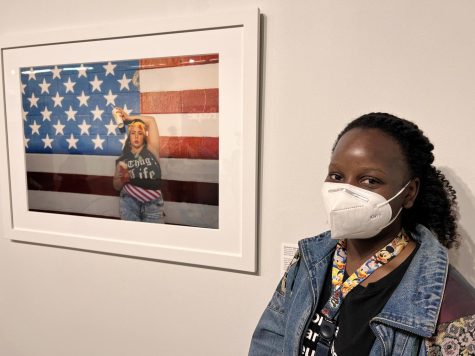 Rachel stands in front of a portrait featuring her favorite artist, Genevieve Gaignard, at the California African American Museum in Los Angeles, Calif. on May 15, 2022. (Brittany Parris | Warrior Life)
