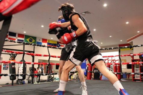 Joey Abudy, 21, of Palos Verdes, Calif. scores with a right cross in a sparring match with Vlad Panin at Sweet Science Boxing & MMA Gym in Hawthorne, Calif. on Thursday, April 7, 2022. Joey started boxing at the age of 17 when he saw Sweet Science Gym featured on a YouTube video. “It was the closest gym to my house,” says Joey. “I was always into sports, but I wasn’t doing anything with myself. I started boxing to keep (myself) busy, and I fell in love with it.” (Kim McGill | Warrior Life)