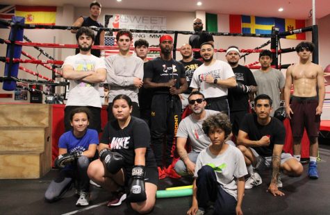 Coaches and boxers gather at Sweet Science Boxing & MMA Gym in Hawthorne, Calif. on Thursday, April 7, 2022. The gym's founder Marco Trejo grew up in Hawthorne, graduated from Hawthorne High School and attended El Camino Community College. “I’ve always liked boxing since I was a young kid,” Trejo says. “But, I didn’t get a chance to pursue boxing until I was in my twenties. By that time, it’s kind of late to be competitive. So, I thought maybe I should open a gym, I love boxing so much.” He opened Sweet Science in 2009. (Kim McGill | Warrior Life)