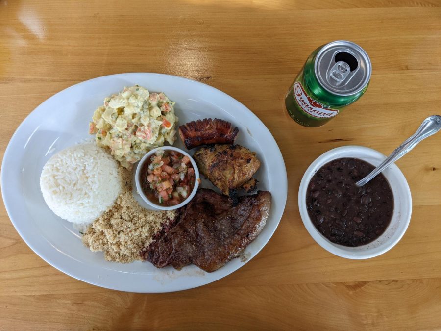 The barbecue plate at Panelas Brazil Cuisine lets you sample steak, chicken and sausage. It is served with black beans on the side and the Brazilian soda Guarana, a great drink to go with it. (Matheus Trefilio | Warrior Life)