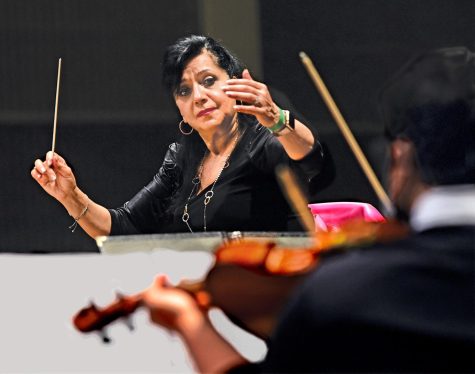 Joanna Nachef conducts her Tuesday night orchestra class with focus and energy. The orchestra class was preparing for a holiday concert in December 2021, after a year of no live performances due to the coronavirus. (Gary Kohatsu | Warrior Life)
