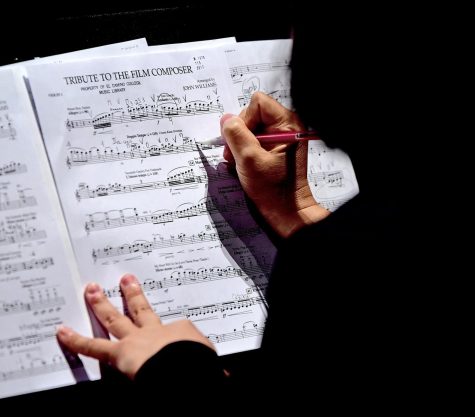 A student makes changes to her music sheet. Reading music is an important part of being a musician, Joanna Nachef says. (Gary Kohatsu | Warrior Life)
