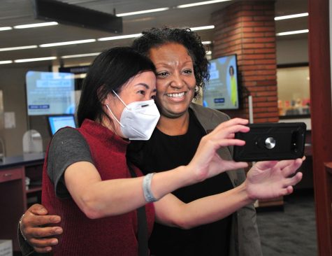 El Camino College President Brenda Thames obliges Loretta Lau's request for a selfie in the Schauerman Library on April 21. Lau, El Camino Library and Learning Research Technician, said she had much admiration for Brenda for her interest in the campus, staff and students. (Gary Kohatsu | Warrior Life)