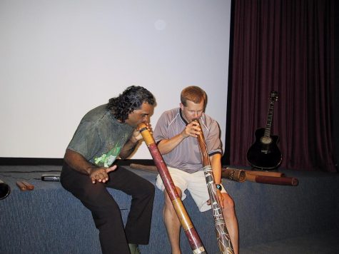 David Hudson (left) teaches William Doyle (right) how to play the didgeridoo during his visit to Australia. The didgeridoo is an
aboriginal instrument. (Photo provided by William Doyle)