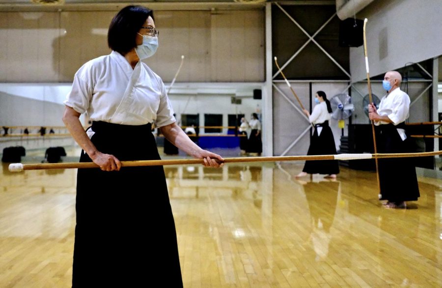 Helen Nakano holding the naginata, a 7-foot-4 weapon in her dojo where she practices, located in the Torrance Cultural Arts Center on Thursday, Oct 21, 2021. (Jose Tobar | Warrior Life)