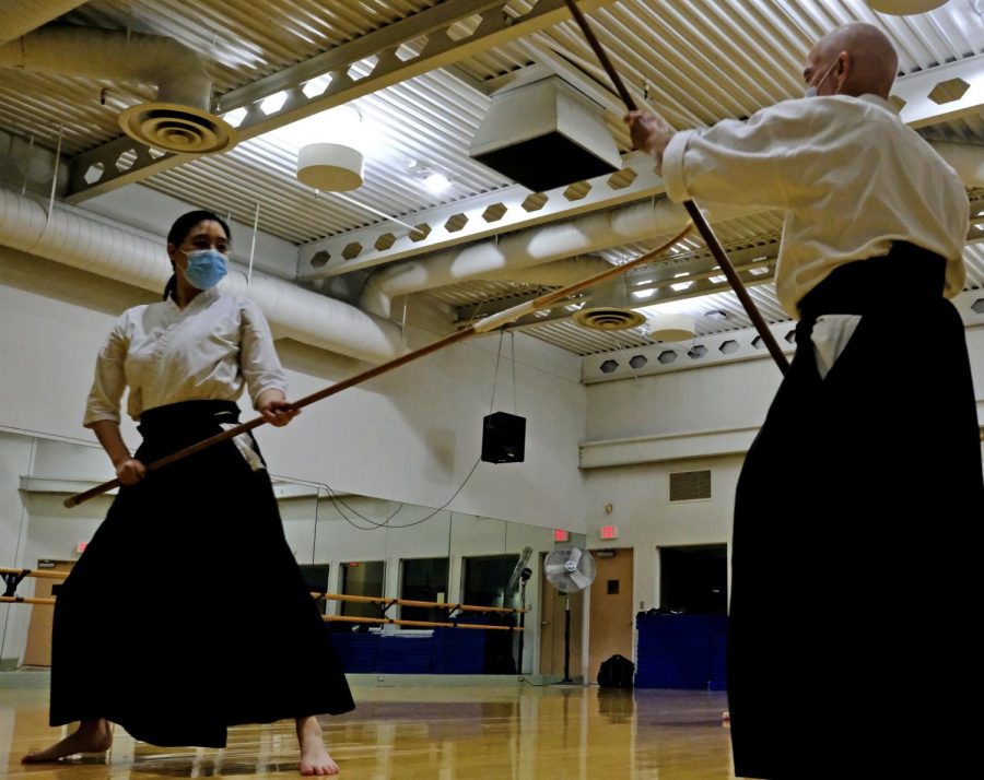 Two Naginataka, or naginata practitioners, Grace Wu (L) and Tony Smith practice their katas, a series of exercises performed in sequence used to perfect their martial arts techniques at the Torrance Cultural Arts Center on Thursday, Oct. 21, 2021. Despite being vaccinated, Nakano requires her students to wear a mask during each class session with some respite during their break when they can step outside for fresh air and water. (Jose Tobar | Warrior Life)