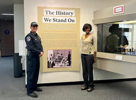 Torrance Police Chief Jeremiah “Jay” Hart (left) and faculty librarian Linda Cooks (right) pose for a photo near the History We Stand On exhibit inside the El Camino College Library on Thursday, Sept. 22. The visit from Hart came as a surprise for many of the library staff. (Delfino Camacho | The Union)
