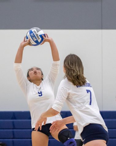 Warriors setter, Jayden Zabala (9), sets up the ball for an attack by middle blocker Alex Perryman (7) on Wednesday, Aug. 31 at the ECC Gym Complex. Zabala had 26 assists in the match against the Raiders. (Ethan Cohen | The Union)
