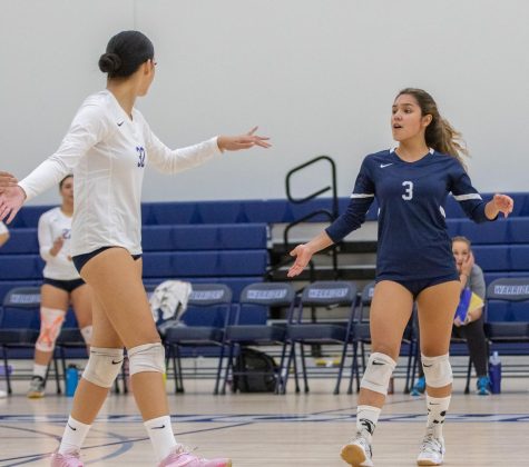 Warriors libero Crystal Salgado (3) and hitter Leafa Juarez (32) celebrate after scoring a point against the Moorpark Raiders on Wednesday, Aug. 31 at the ECC Gym Complex. Salgado would lead the team with 10 digs and Juarez with a total of 12 kills. (Ethan Cohen | The Union).