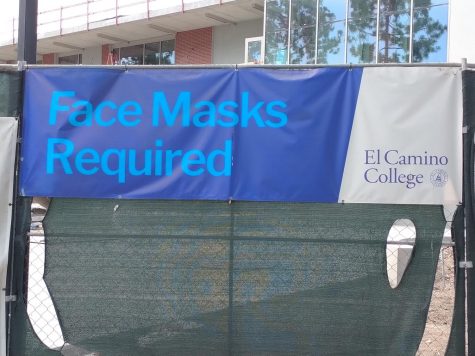 This banner on the construction fence in between the library and the music building still remains on Sept. 7, 2022. Even though face masks are required in some areas on campus, most areas now are highly recommended and based on teacher discretion.