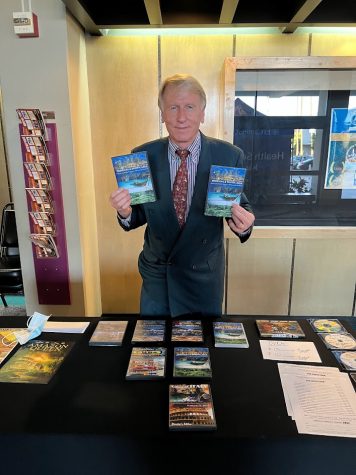 Film producer and director, Marlin Darrah, holding copies of his film Tropical and Exotic Asia at a table with other of his films available for sale on Monday Sept. 19. (Eddy Cermeno | The Union) Photo credit: Eddy Cermeno
