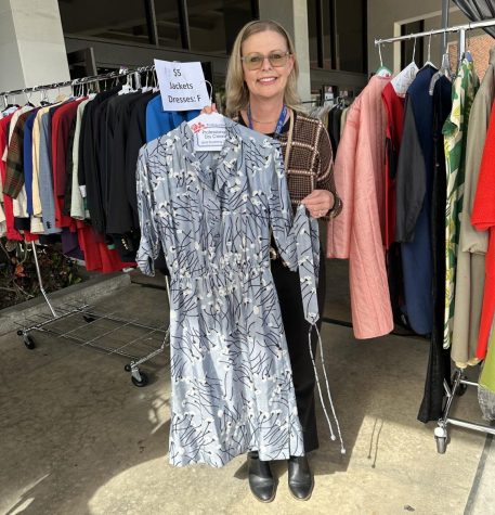 Ann O'Brien, executive director of marketing and communications, outside the Marsee Auditorium with the silk dress she bought at the Halloween Costume Sale, Thursday, Oct. 20, 2022.
