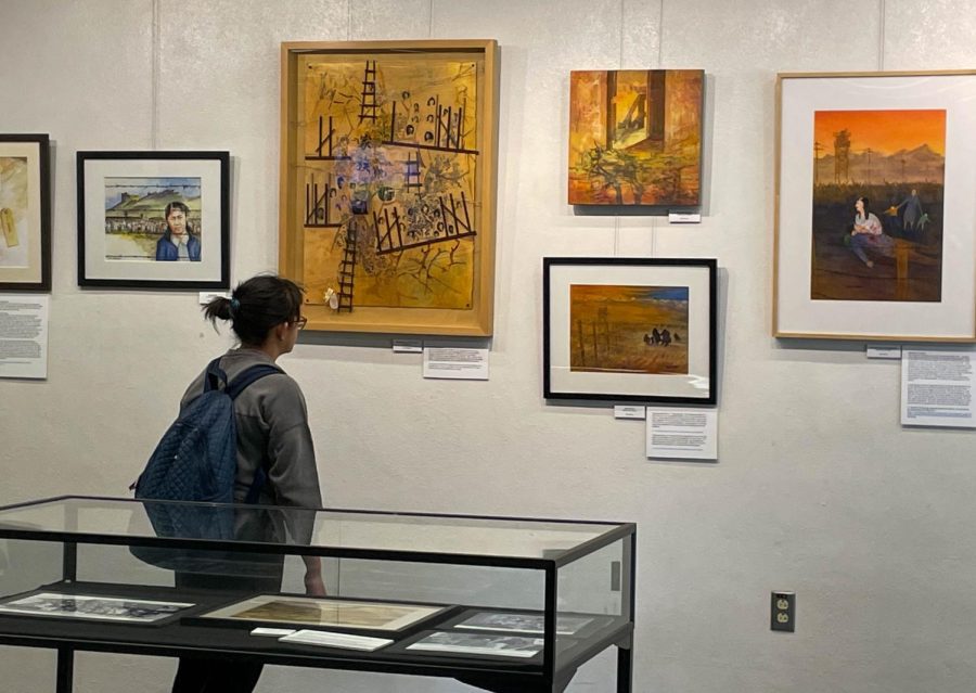 Mary Calingasan looks over the art pieces portraying the internment of Japanese Americans. The event was created by Debra Mochidome and was held in El Caminos library from 1 to 3 p.m. on Oct. 13. (Ash Hallas | The Union)