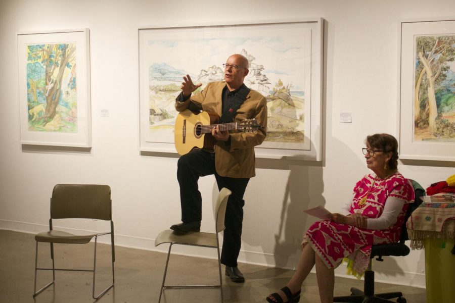Musician Hector Marquez (left) assists lecturer Miriam Quezado-Hagerman (right) by giving some history for the Mexican folk song La Llorona at a new art exhibit at the El Camino Art Gallery on Saturday, Oct. 15. Marquez played a version of La Patita, a famous Mexican childrens song by childrens musical artist Cri-Cri. (Delfino Camacho | The Union)